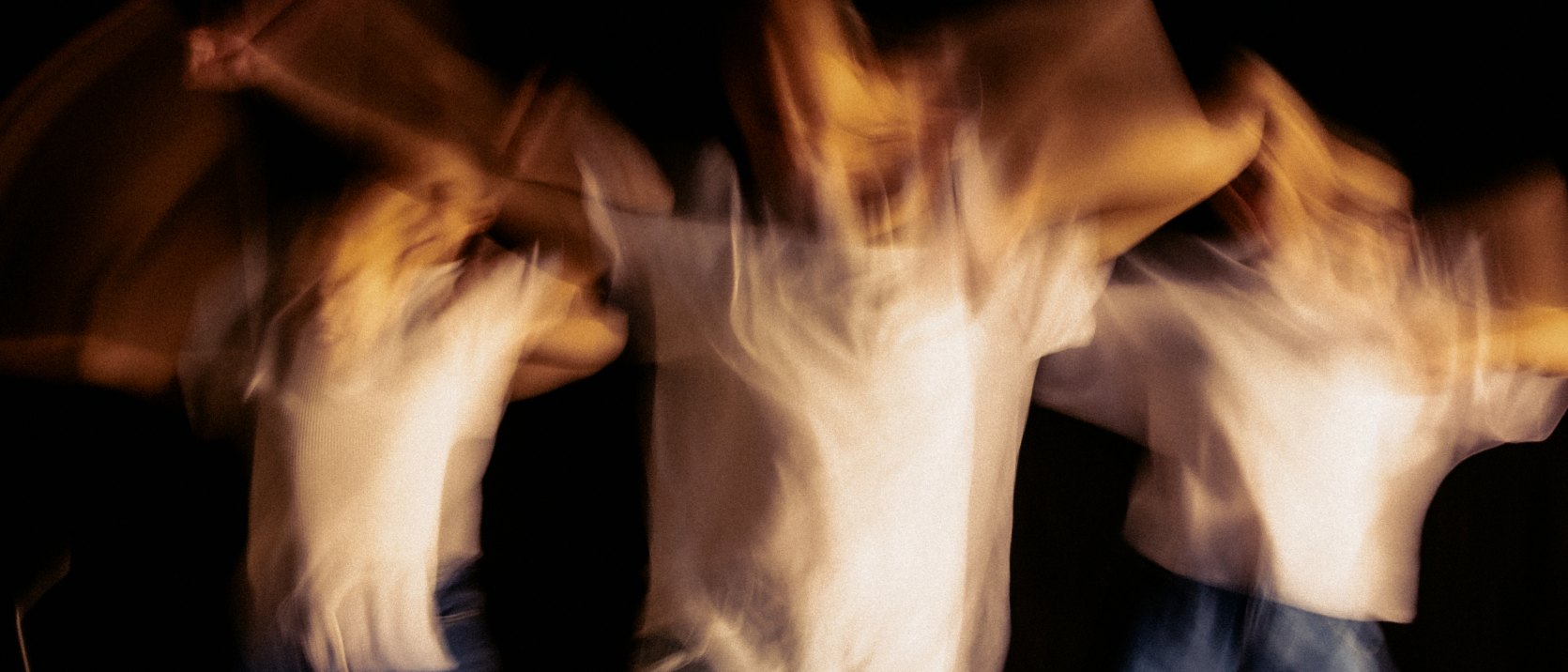 Three dancers mid movement